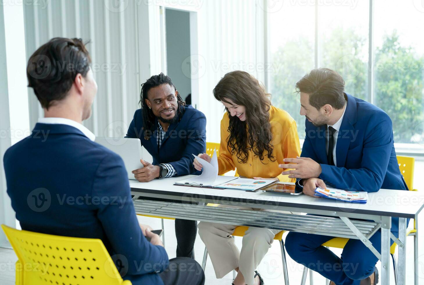 Job interview concept. Diverse hr team doing job interview with a man in business office. Human resources team interviewing a potential job candidate. Hiring, employment, and recruitment concept. photo