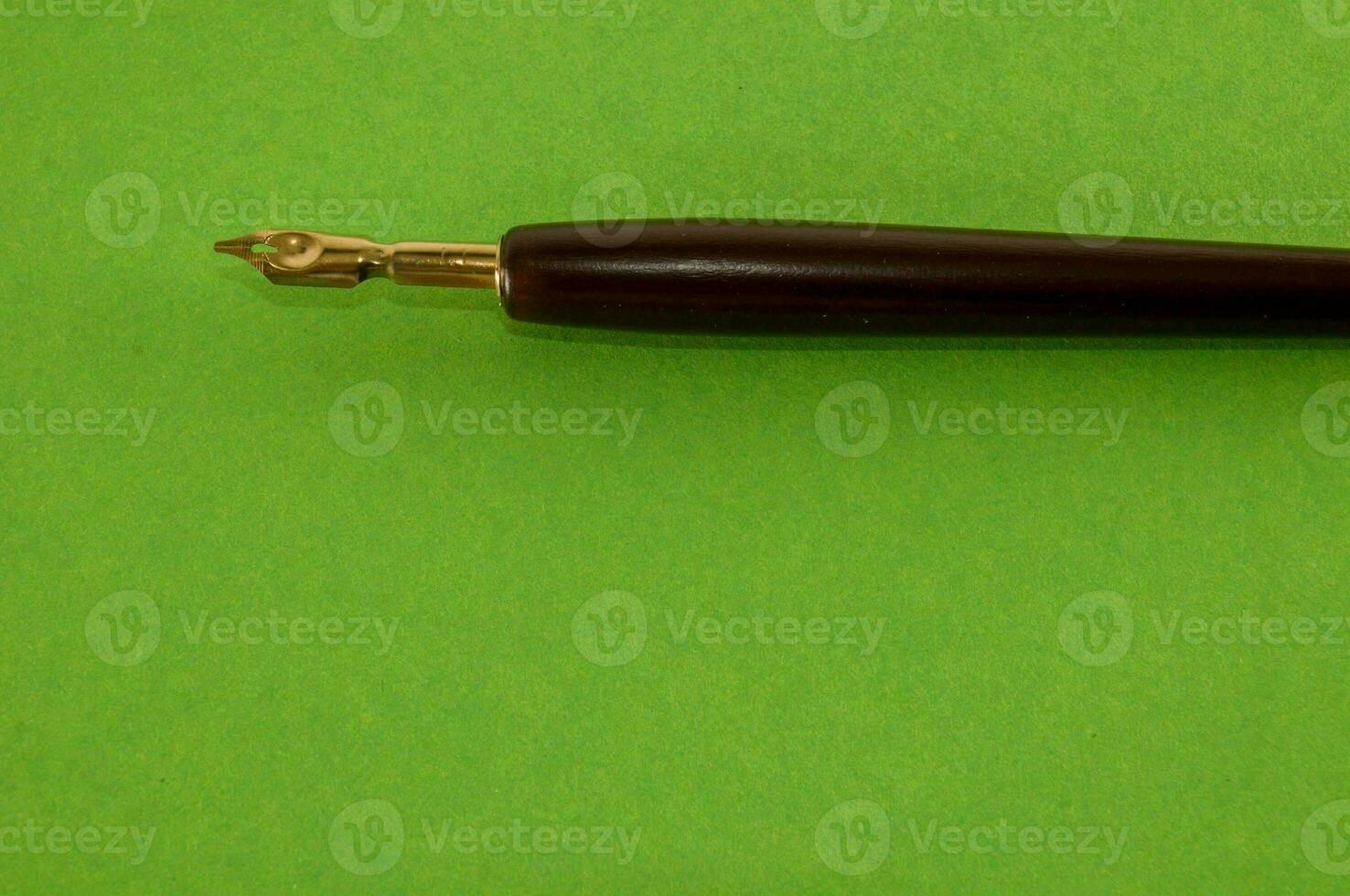 a fountain pen on a green background photo