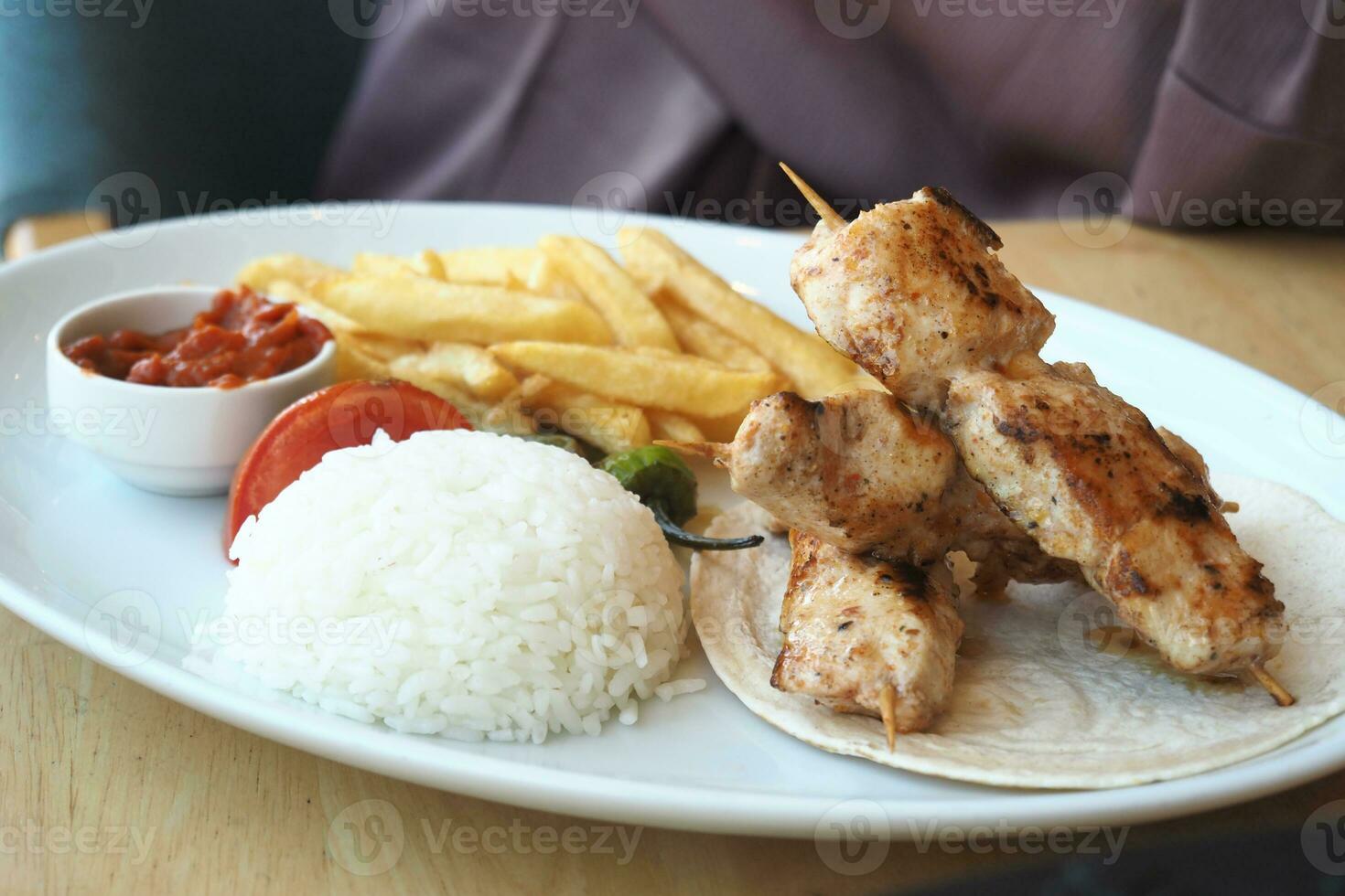 Chicken skewers with french fries and rice photo