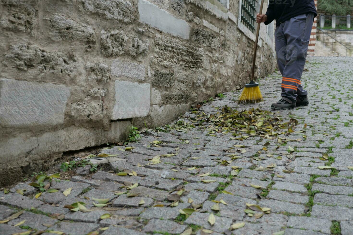 cleaning the fallen leaves in the park photo