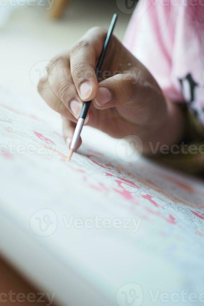 women hand holding brush with paint photo