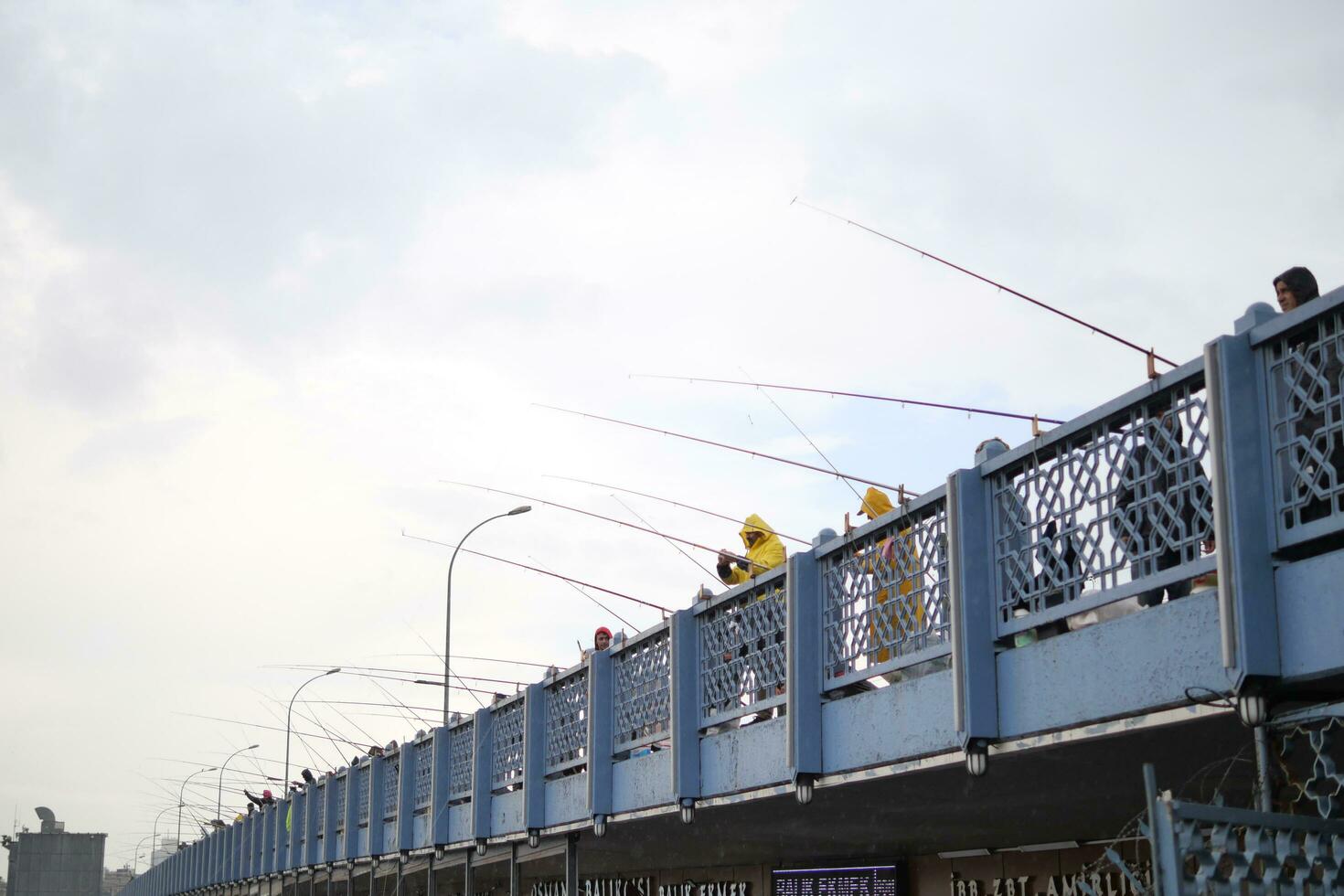 Turkey istanbul 12 january 2023. Fisherman with rod, spinning reel on bridge photo