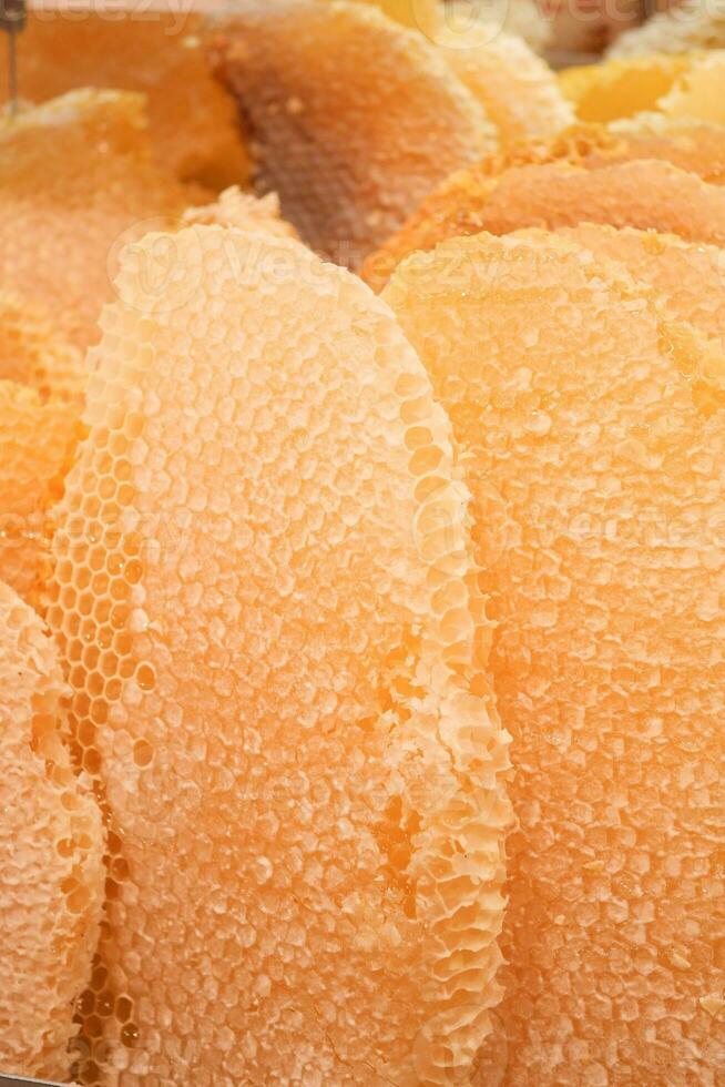 close up of fresh honey with comp in a jar photo
