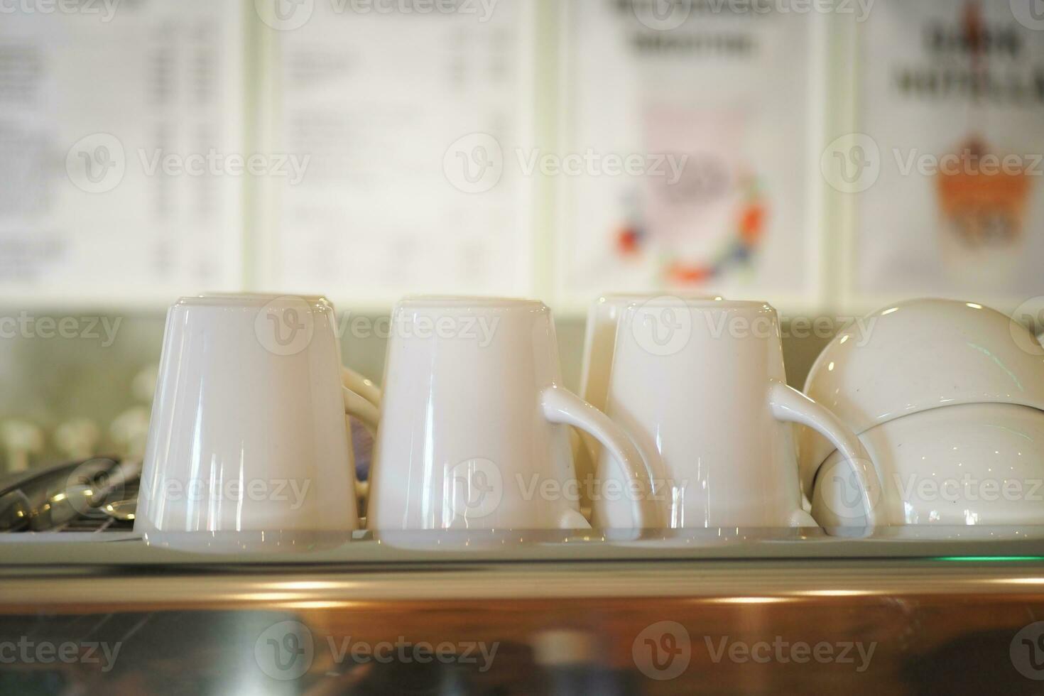 coffee cup lined up on a coffee machine at cafe . photo