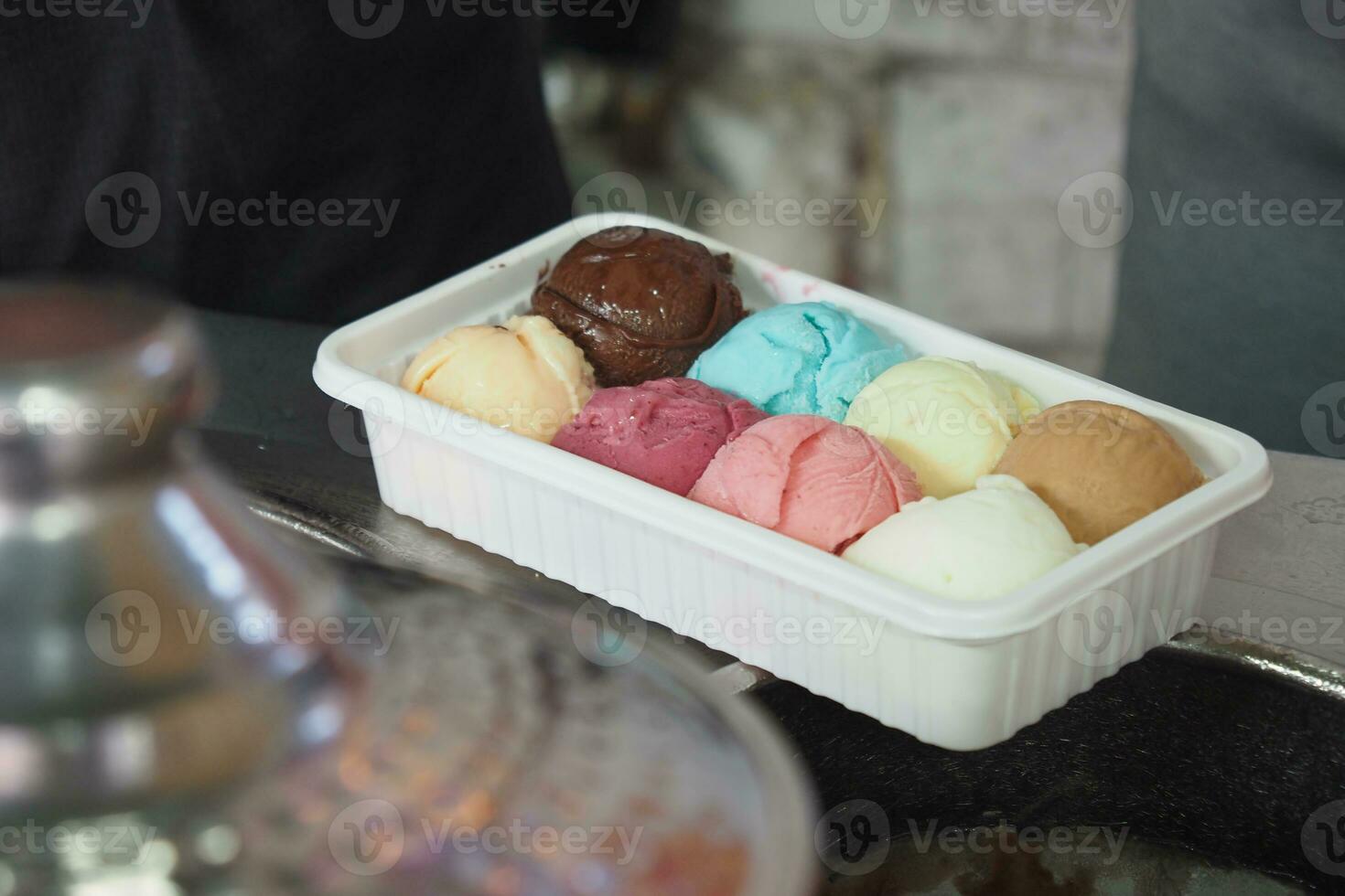 different flavor ice cream in a plastic container photo