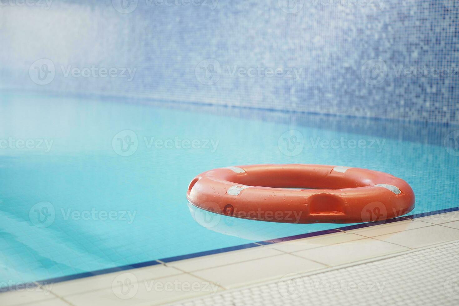 Red life buoy in swimming pool.. Help and support concept. photo