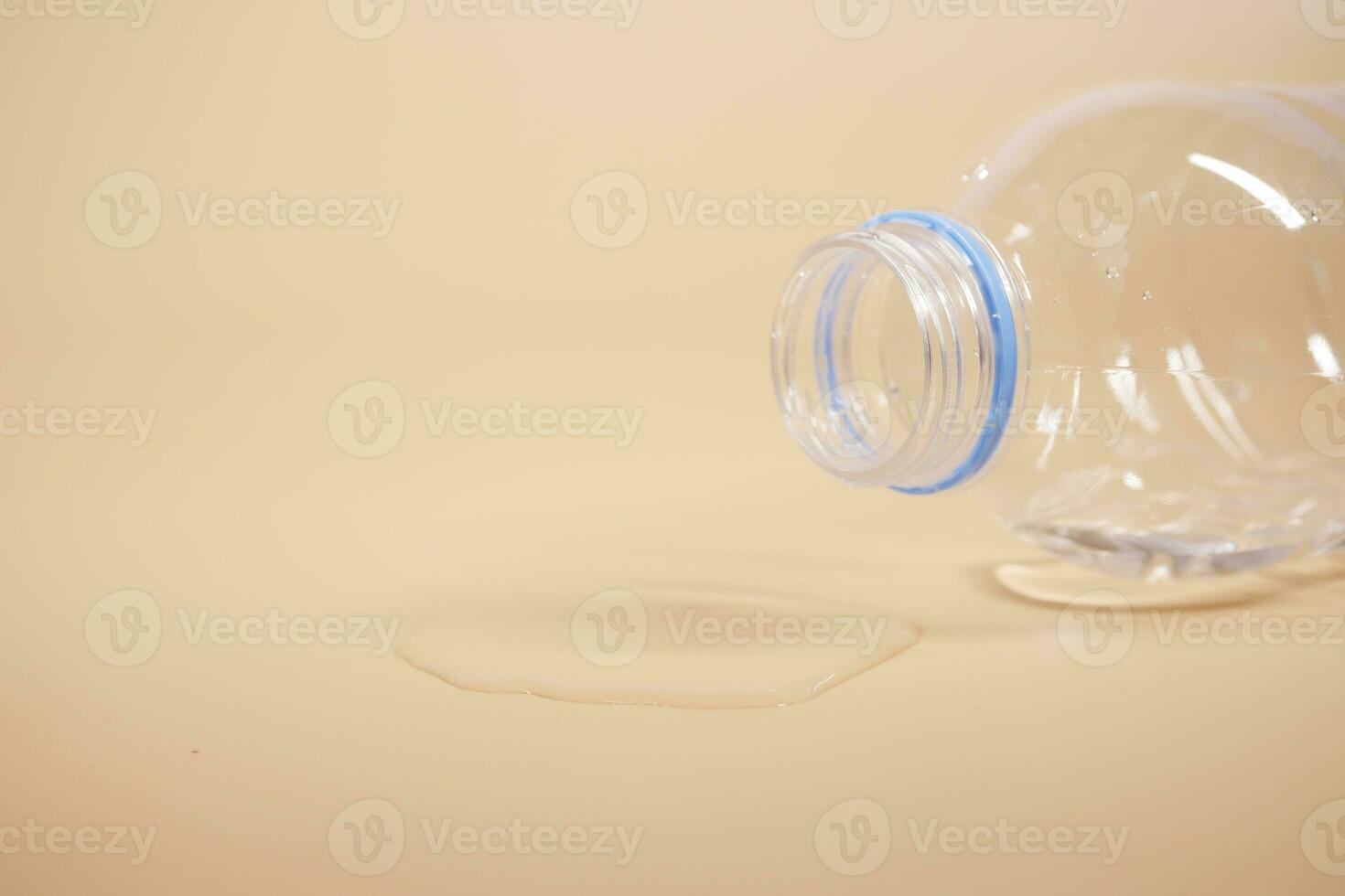 a bottle of water spilled on a table , photo