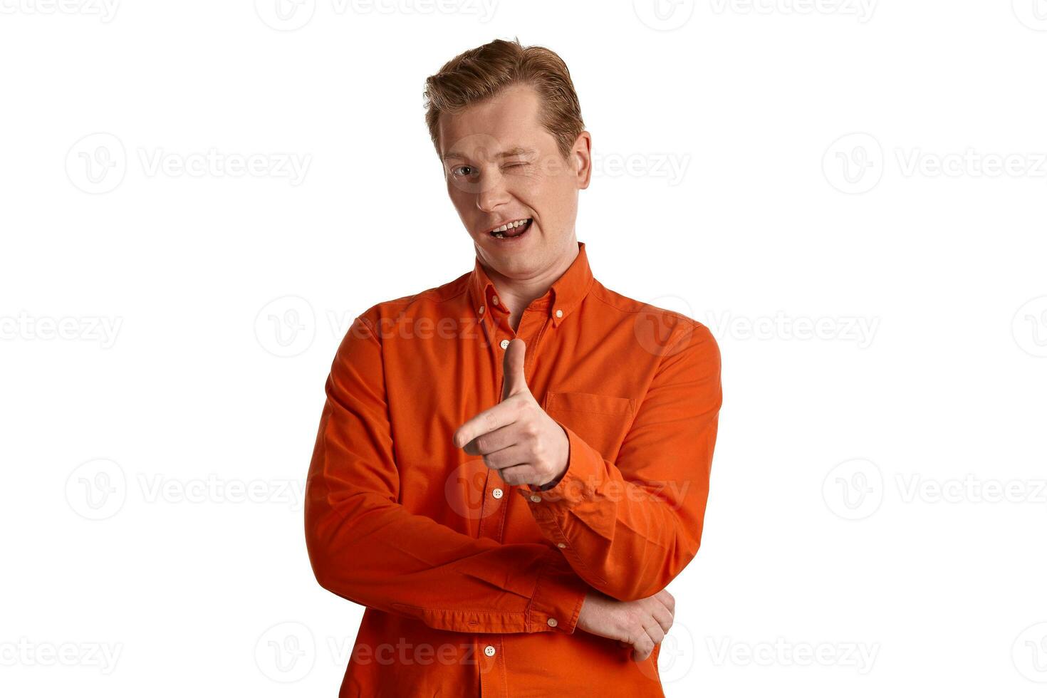 Close-up portrait of a ginger guy in orange shirt posing isolated on white background. Sincere emotions. photo