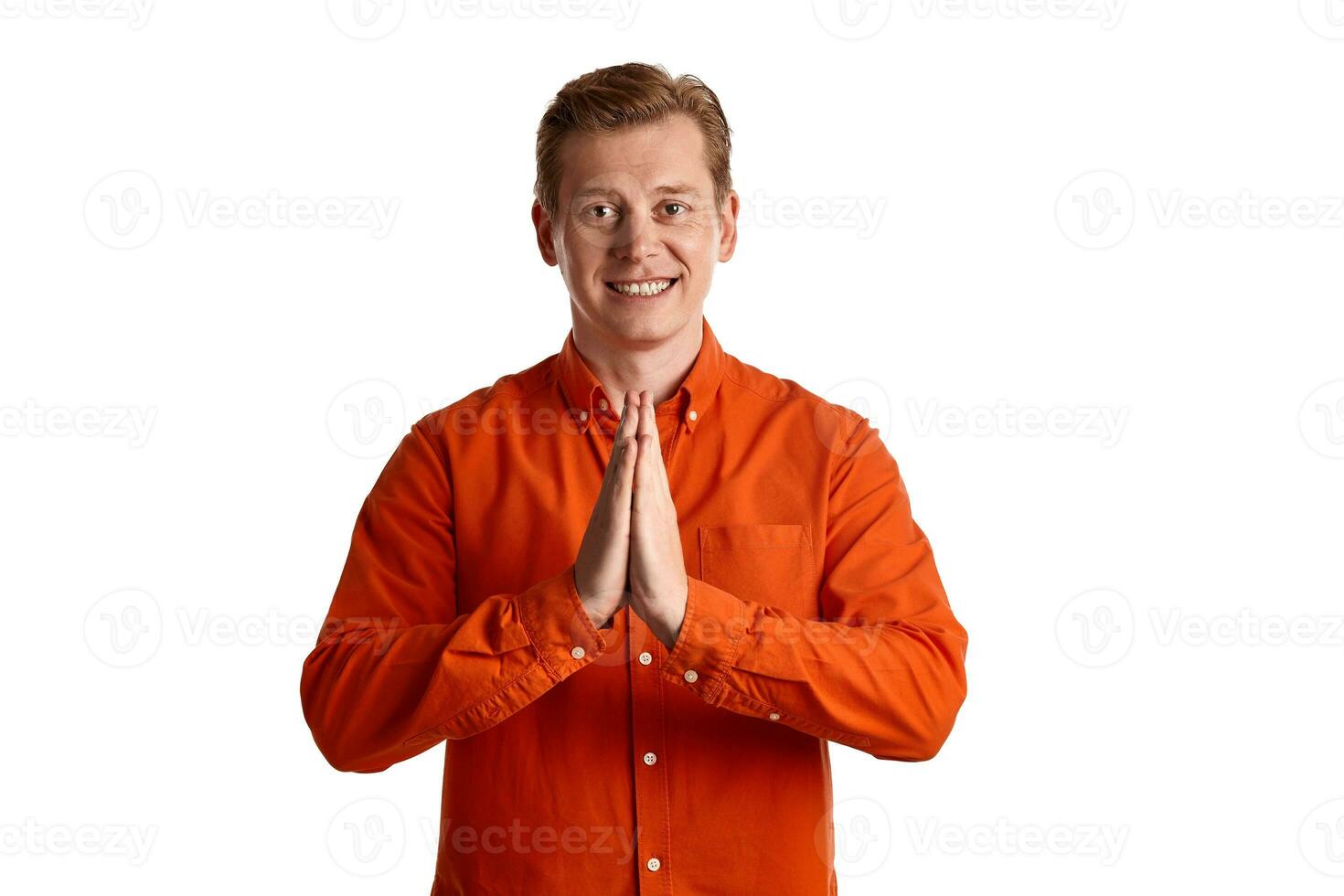 Close-up portrait of a ginger guy in orange shirt posing isolated on white background. Sincere emotions. photo