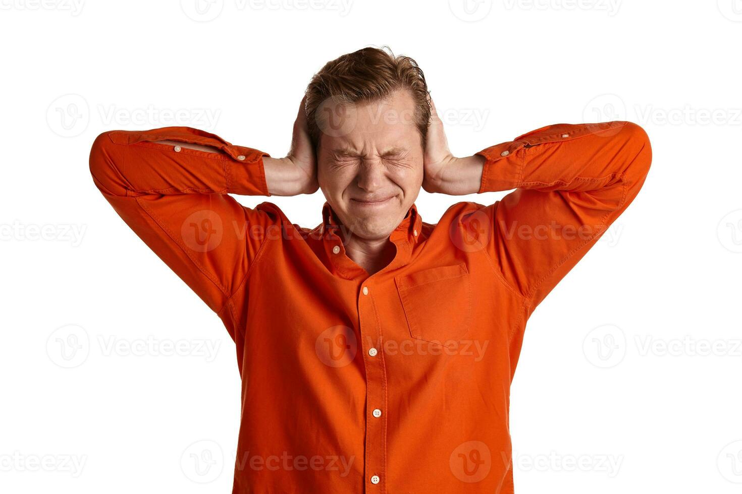 Close-up portrait of a ginger guy in orange shirt posing isolated on white background. Sincere emotions. photo