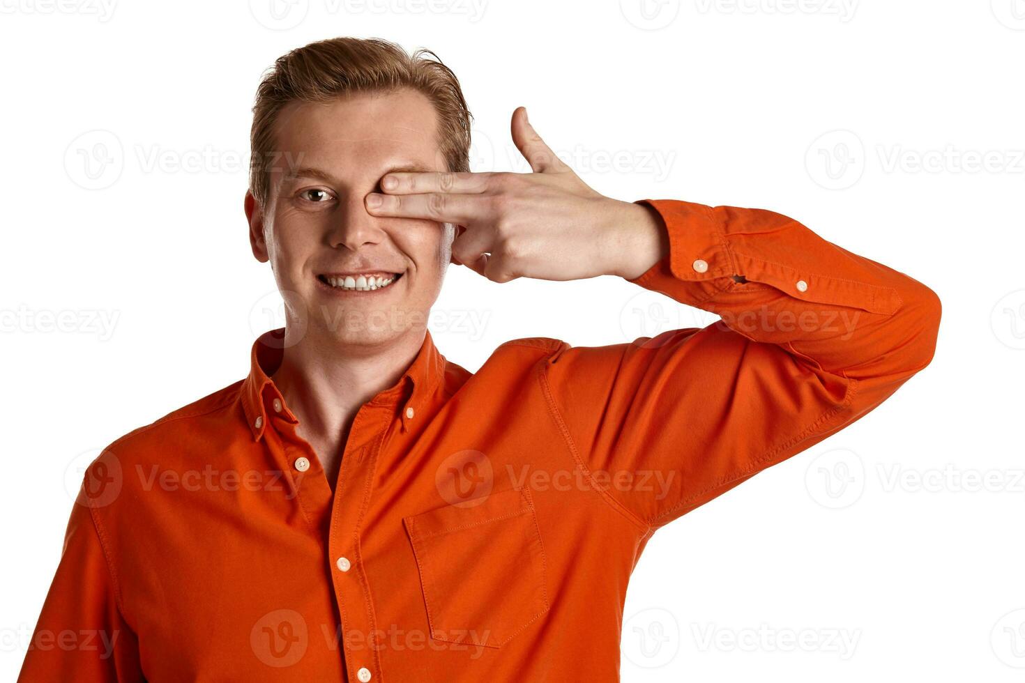 Close-up portrait of a ginger guy in orange shirt posing isolated on white background. Sincere emotions. photo
