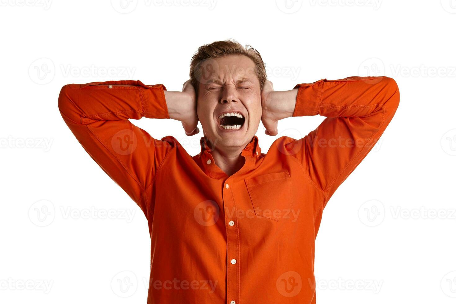 Close-up portrait of a ginger guy in orange shirt posing isolated on white background. Sincere emotions. photo
