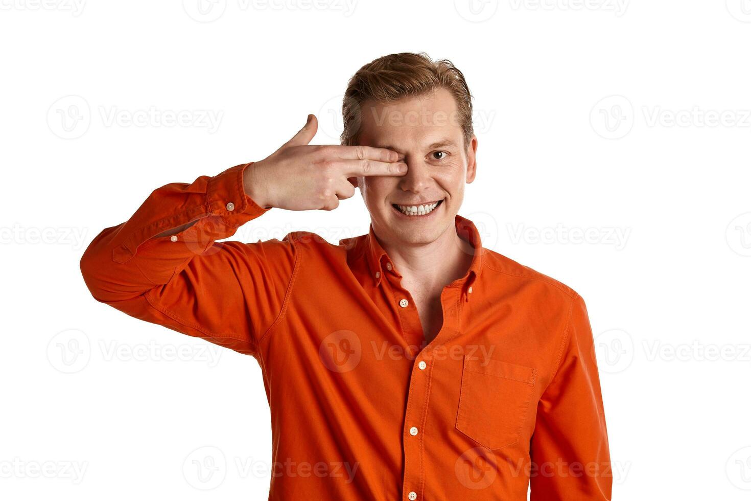 Close-up portrait of a ginger guy in orange shirt posing isolated on white background. Sincere emotions. photo