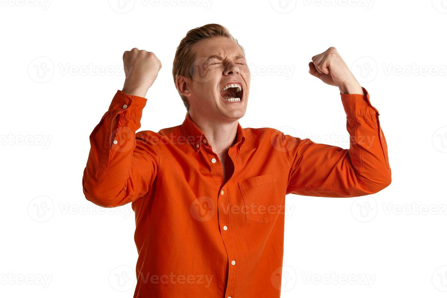 Close-up portrait of a ginger guy in orange shirt posing isolated on white background. Sincere emotions. photo