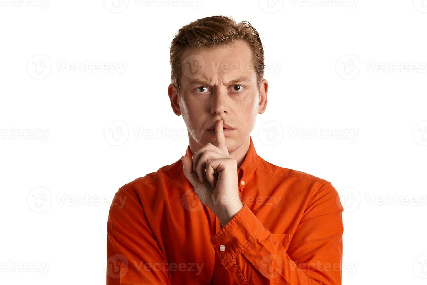 Close-up portrait of a ginger guy in orange shirt posing isolated on white background. Sincere emotions. photo