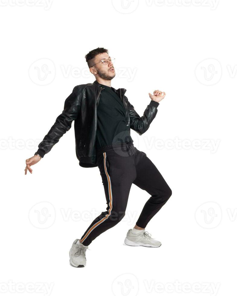 Full-length photo of a funny guy dancing in studio isolated on white background.