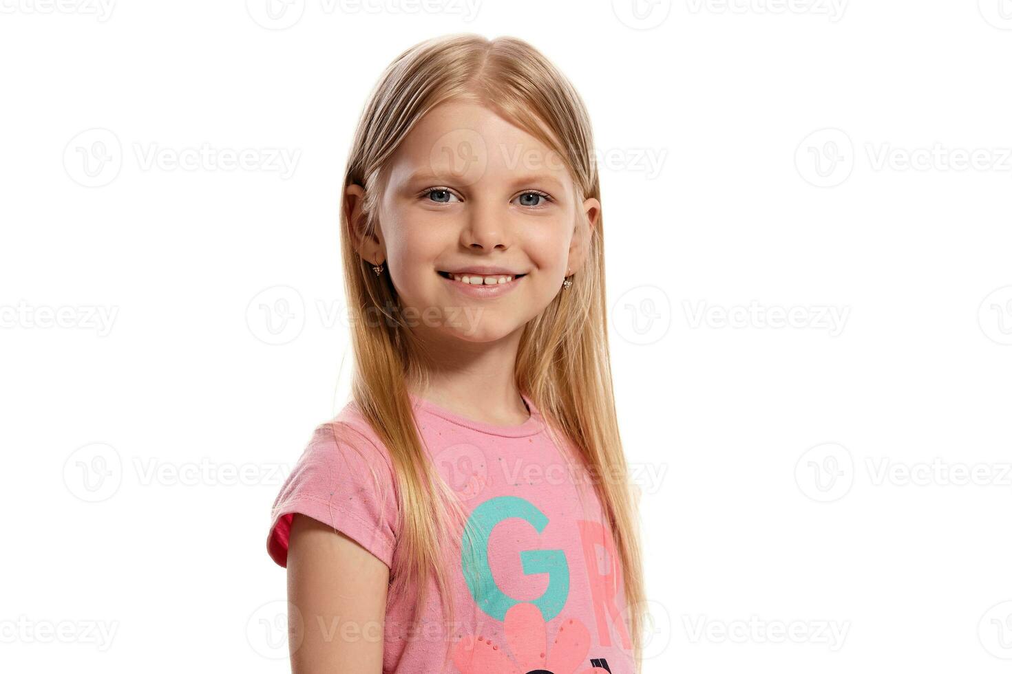 Close-up portrait of a nice blonde little kid in a pink t-shirt posing isolated on white background. photo