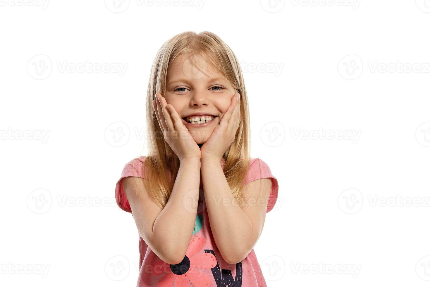 Close-up portrait of a nice blonde little kid in a pink t-shirt posing isolated on white background. photo