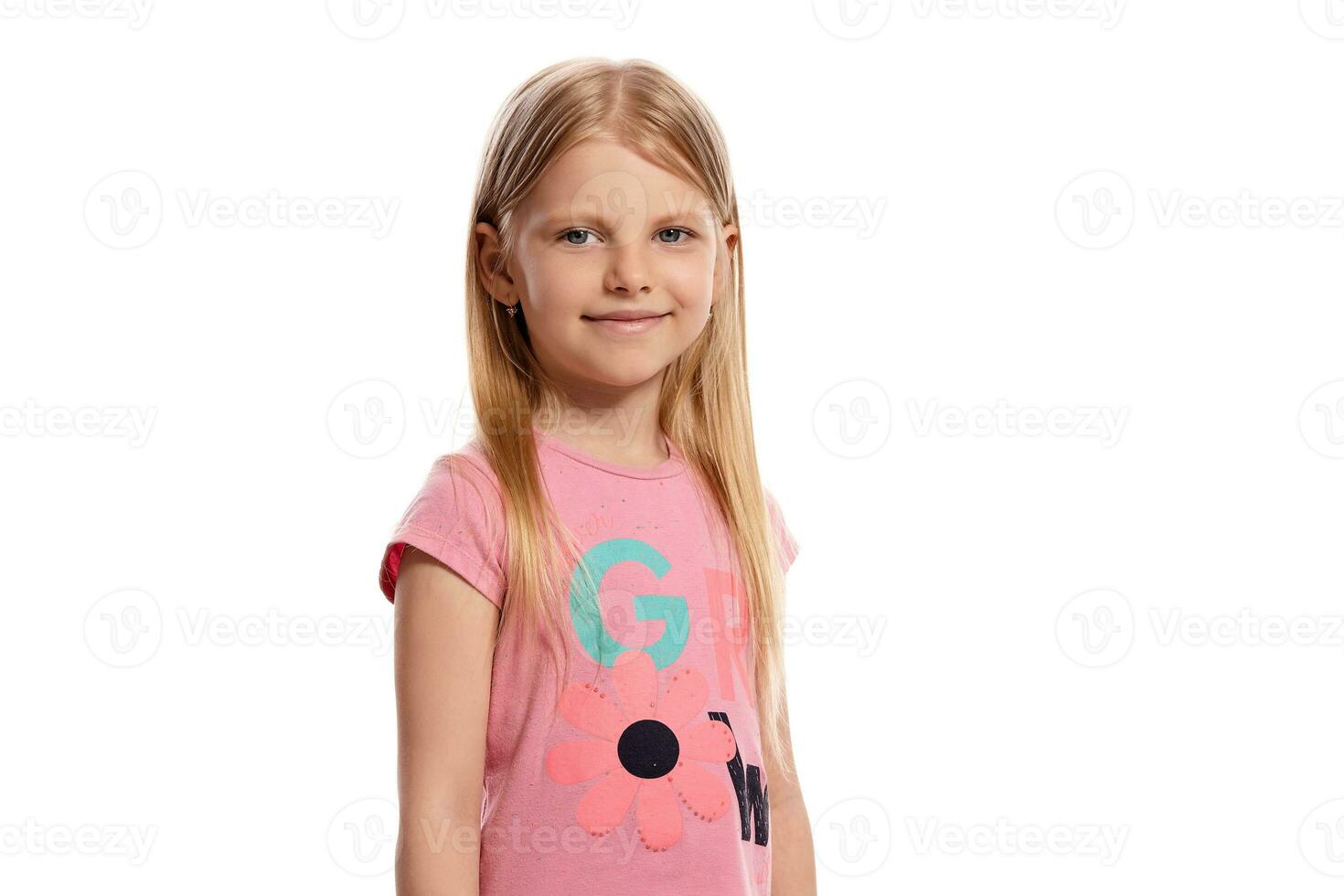 Close-up portrait of a nice blonde little kid in a pink t-shirt posing isolated on white background. photo