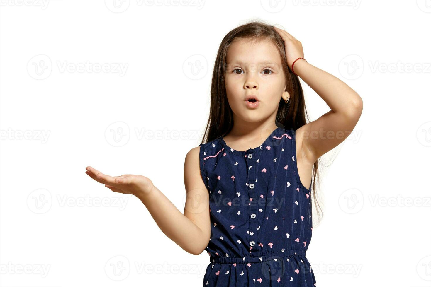 Close-up studio shot of beautiful brunette little girl posing isolated on white studio background. photo