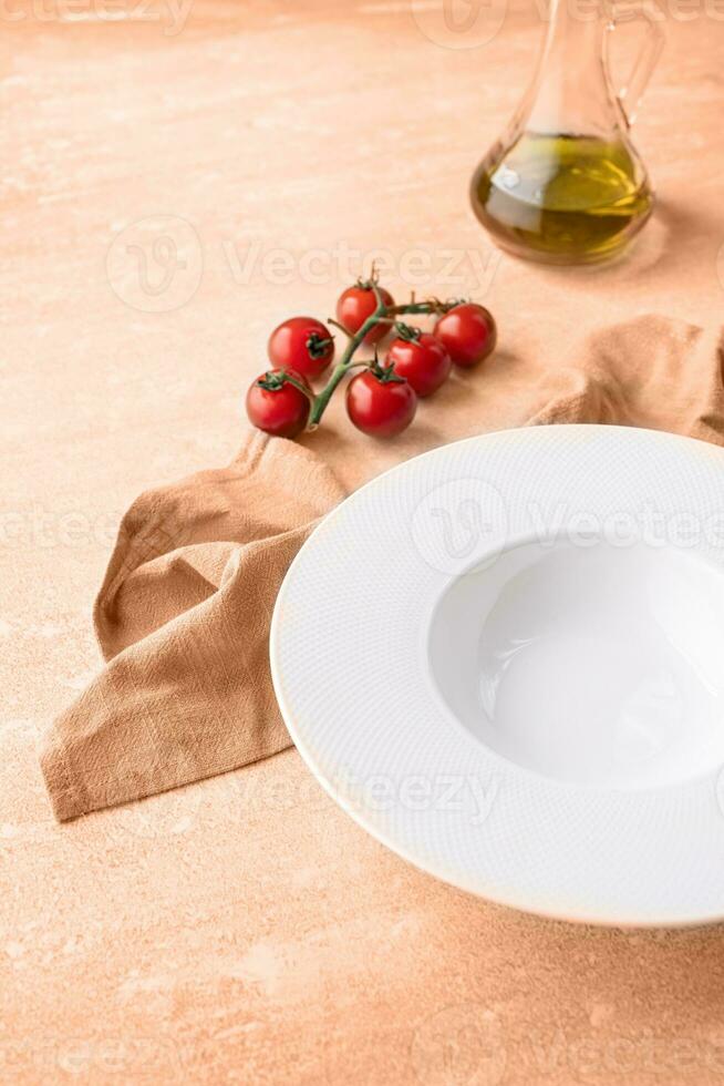 Color of the year 2024, Peach Fuzz. empty plate for serving pasta or soup, on blue background photo