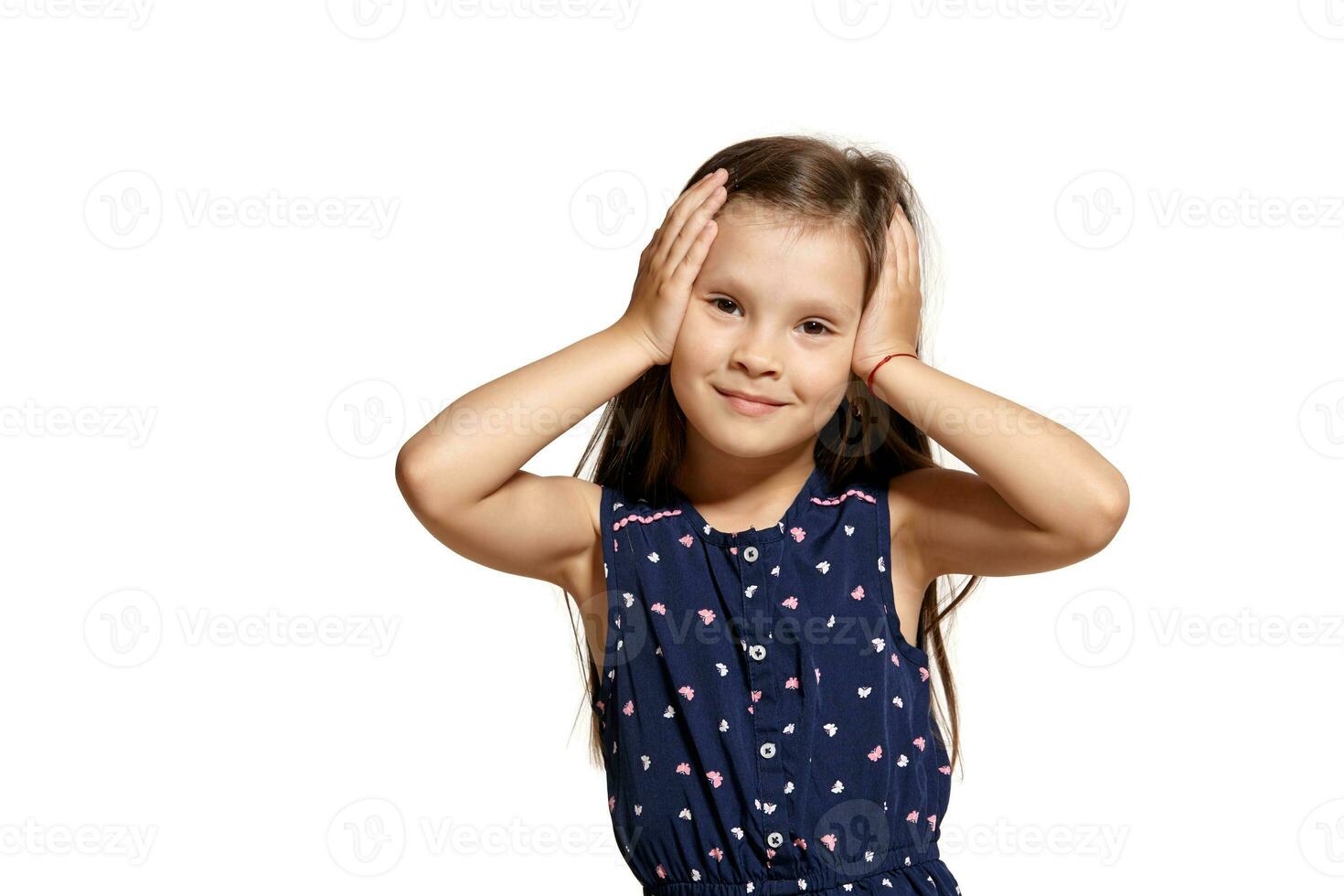 Close-up studio shot of beautiful brunette little girl posing isolated on white studio background. photo