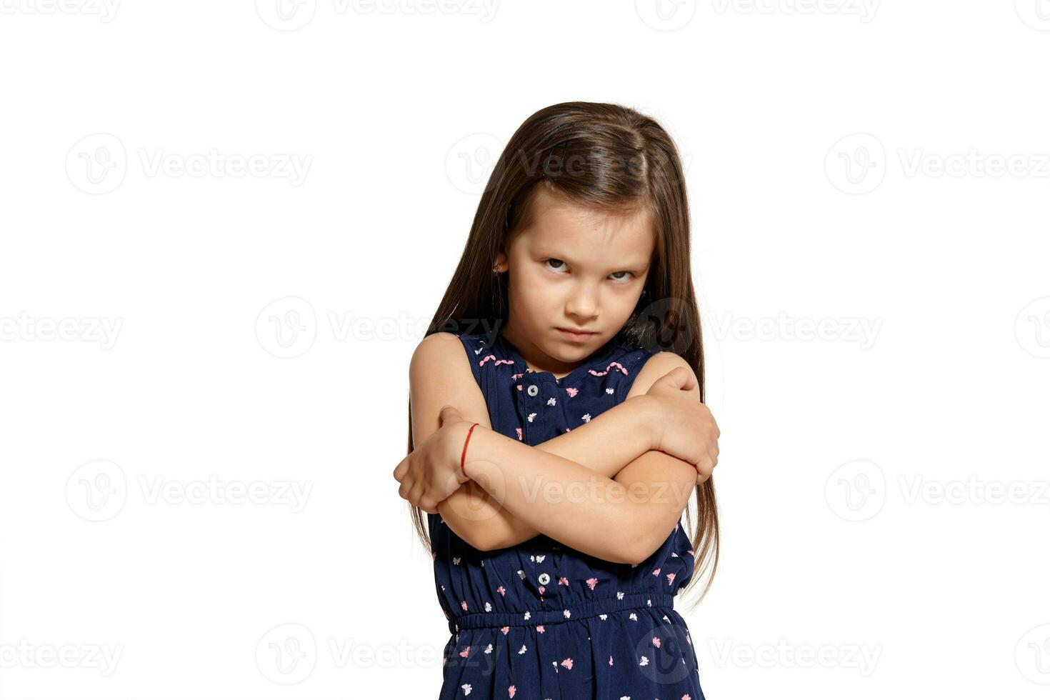 Close-up studio shot of beautiful brunette little girl posing isolated on white studio background. photo