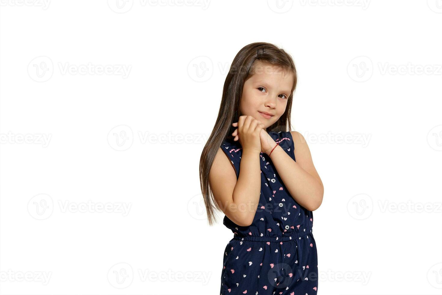 Close-up studio shot of beautiful brunette little girl posing isolated on white studio background. photo