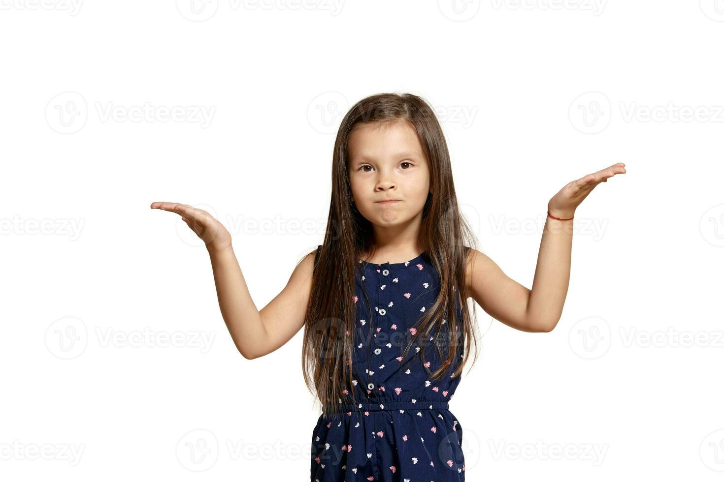 Close-up studio shot of beautiful brunette little girl posing isolated on white studio background. photo