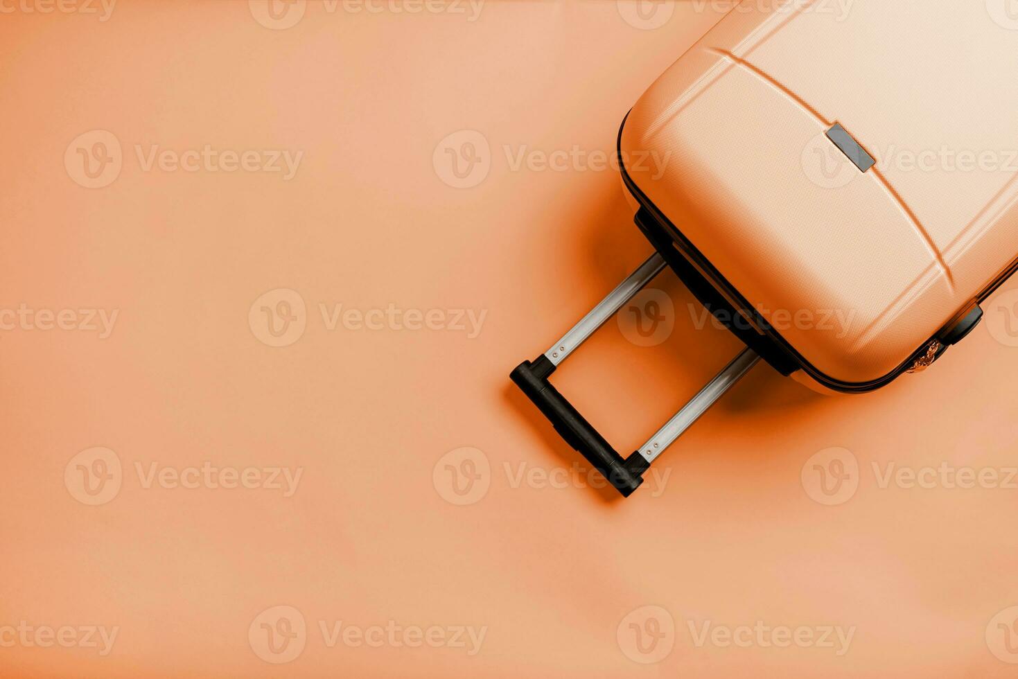 Color of the year 2024, Peach Fuzz.  Top view travel bag or suitcase on solid background copy space photo