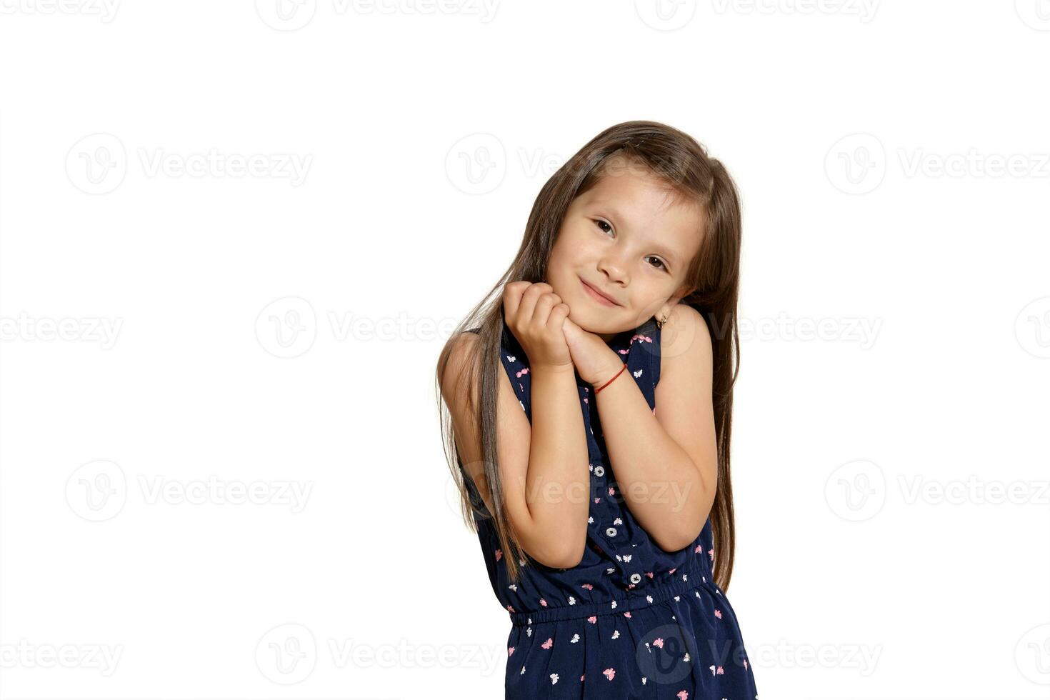 Close-up studio shot of beautiful brunette little girl posing isolated on white studio background. photo