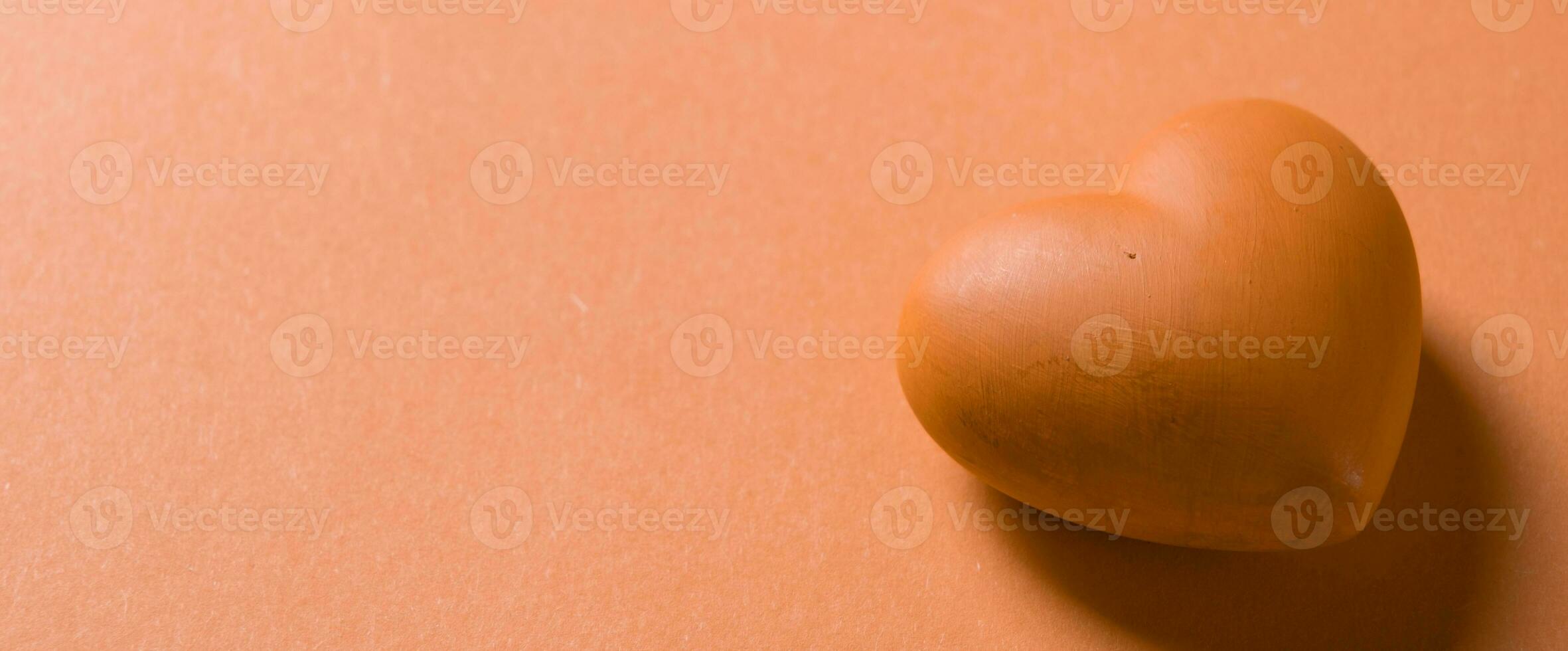 Valentines day. Red heart with copy space isolated on orange photo