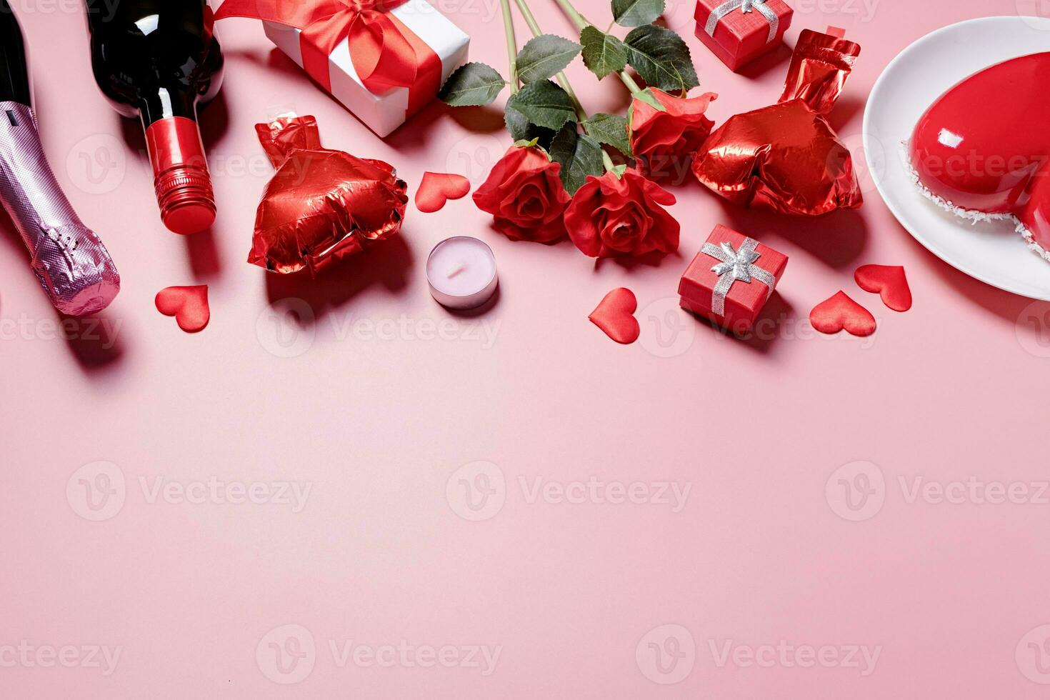 heart shaped glazed valentine cake and flowers on pink background photo