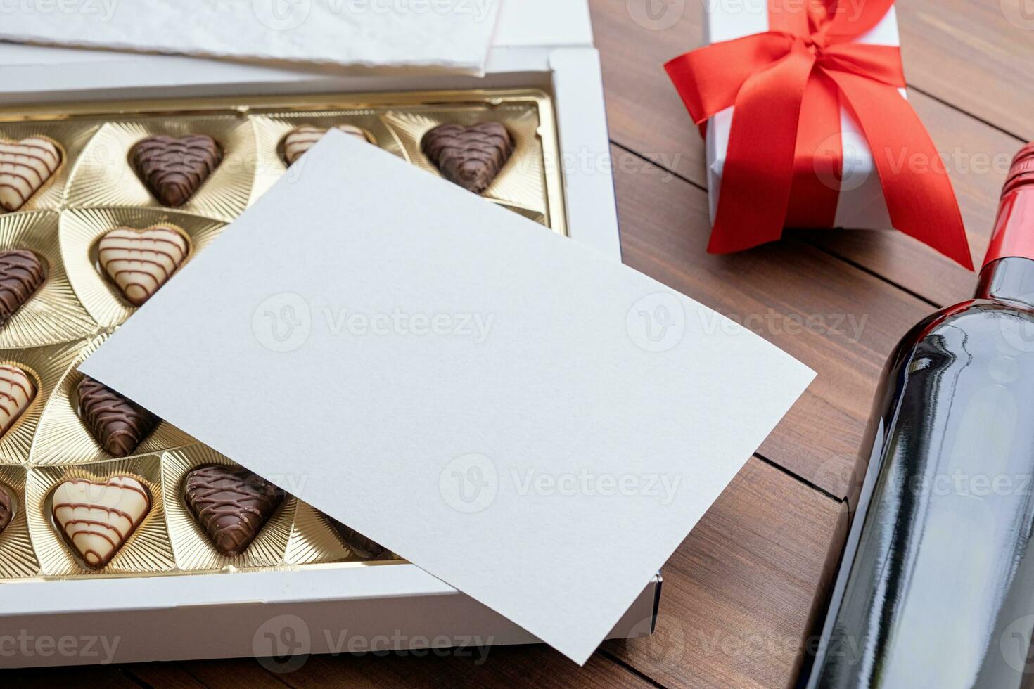 valentine sweet chocolate and red wine on wooden background photo