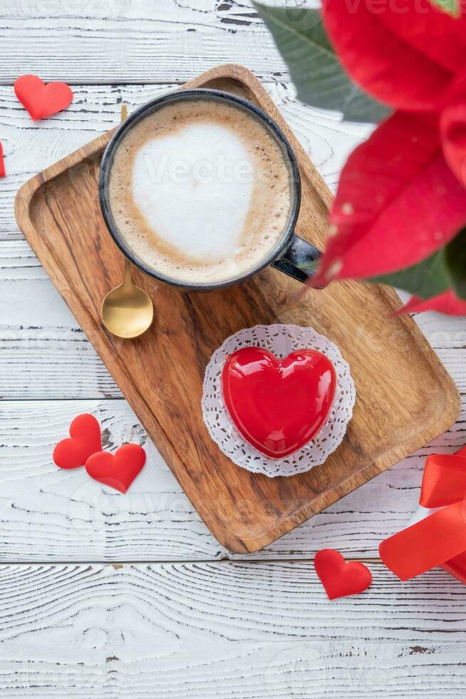 heart shaped glazed valentine cake in bed on wooden tray photo