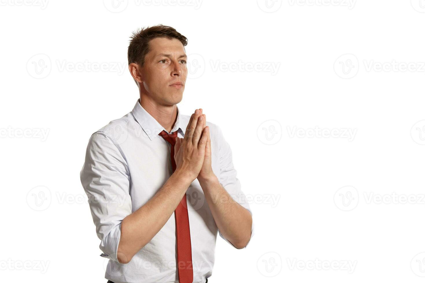 Portrait of a young brunet man posing in a studio isolated over a white background. photo