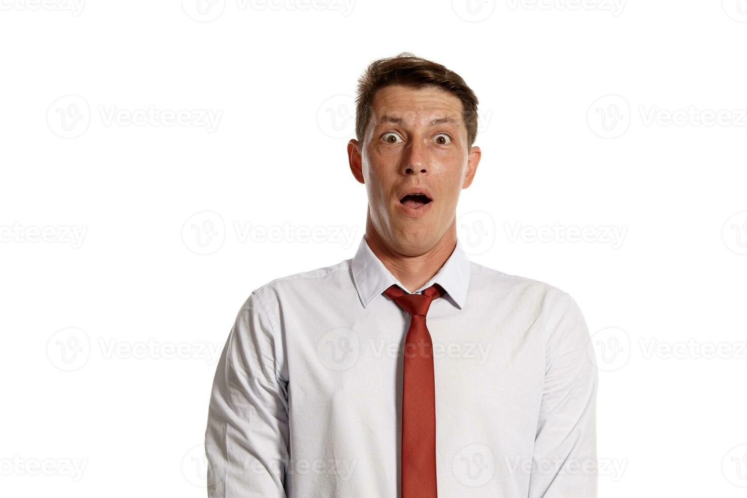 Portrait of a young brunet man posing in a studio isolated over a white background. photo