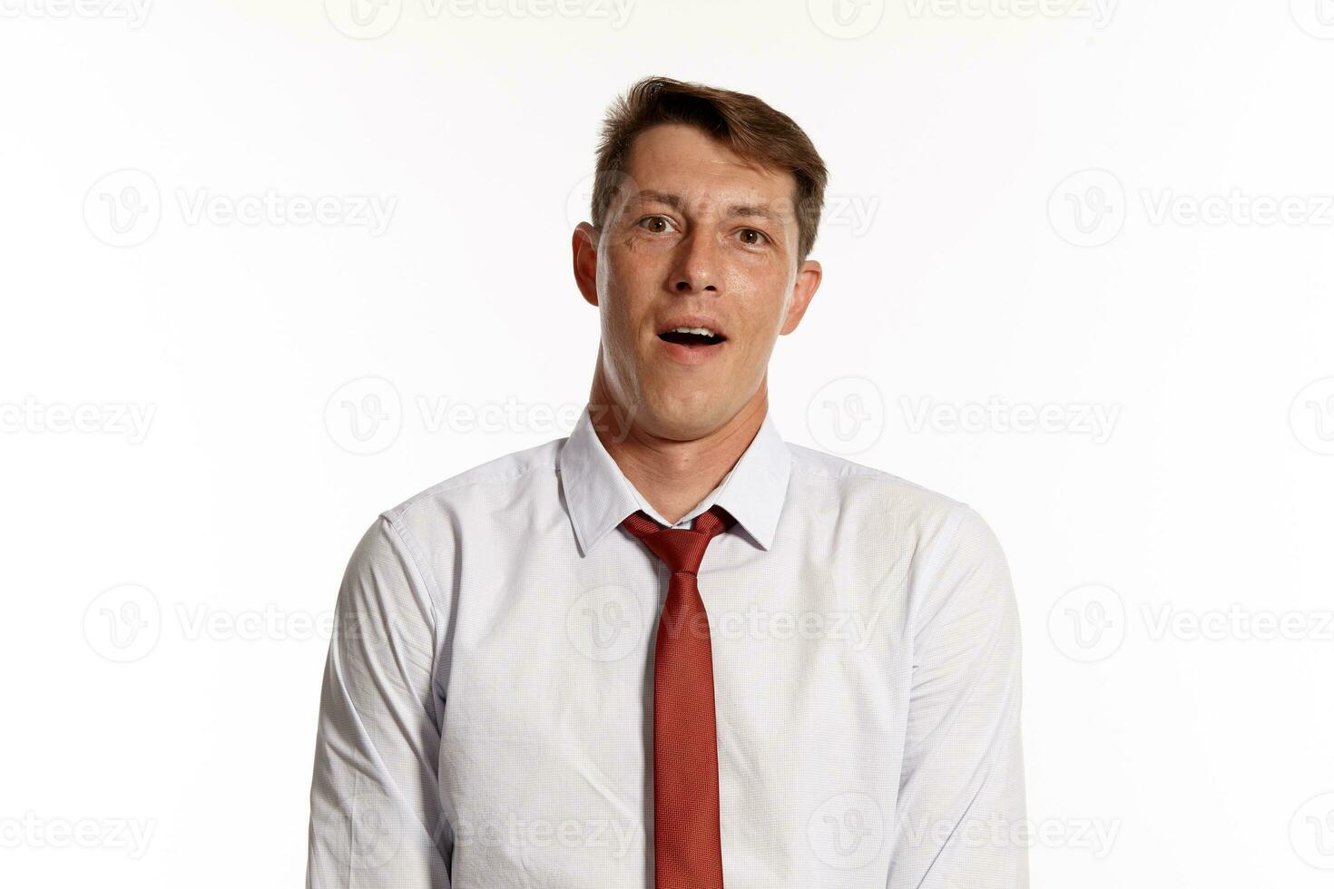 Portrait of a young brunet man posing in a studio isolated over a white background. photo