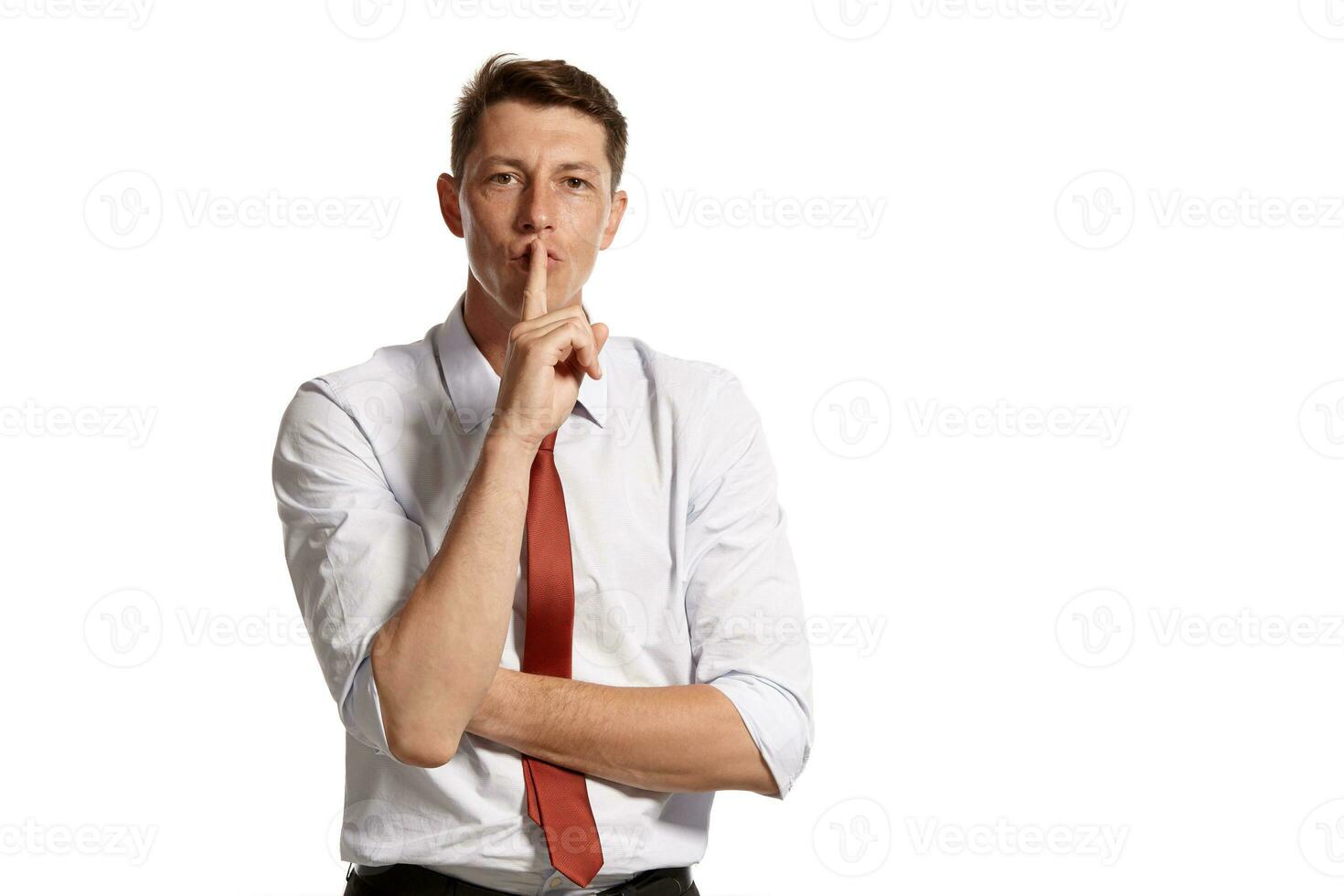 Portrait of a young brunet man posing in a studio isolated over a white background. photo