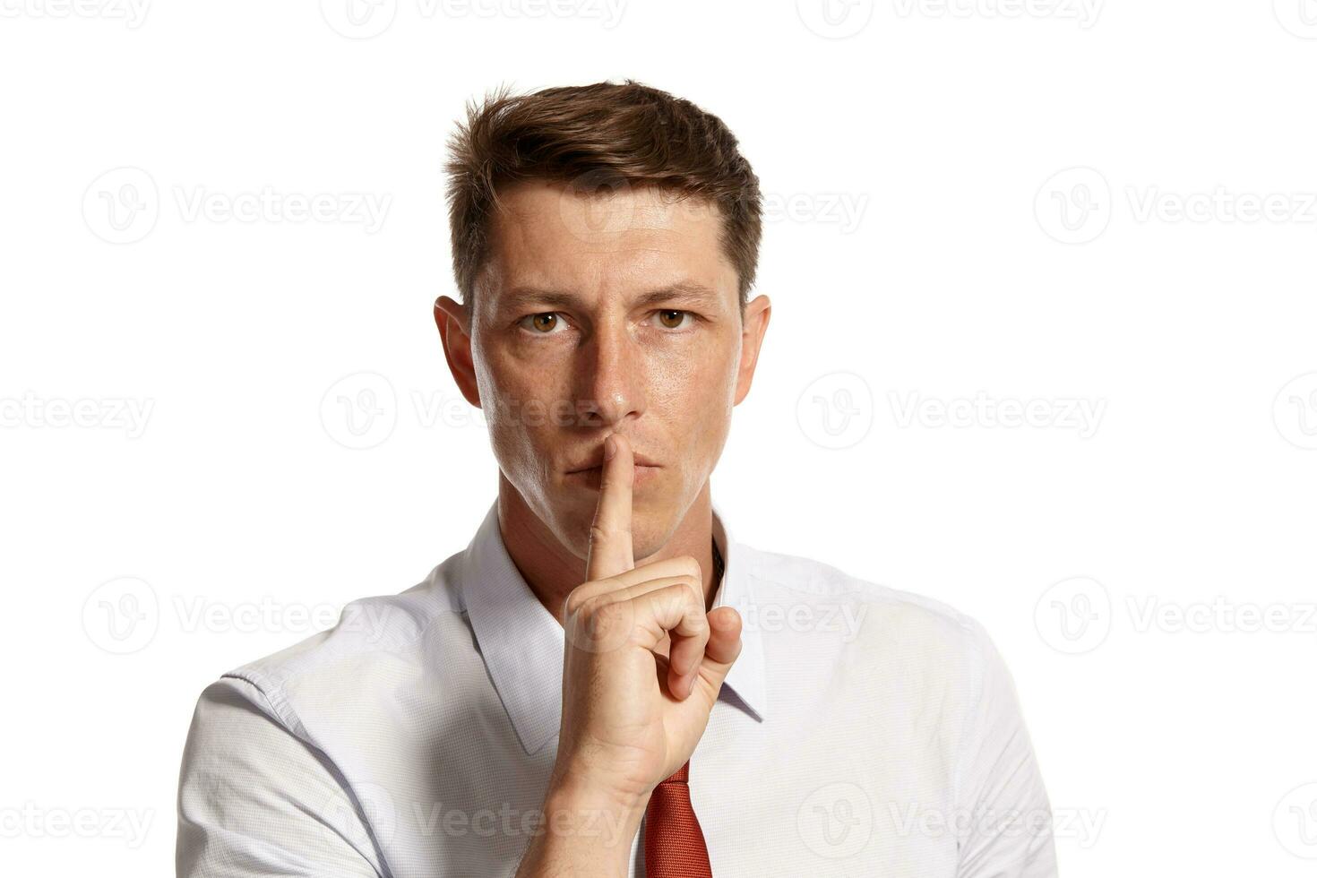 Portrait of a young brunet man posing in a studio isolated over a white background. photo