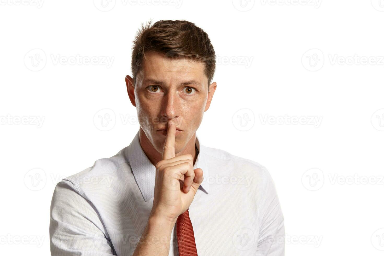 Portrait of a young brunet man posing in a studio isolated over a white background. photo