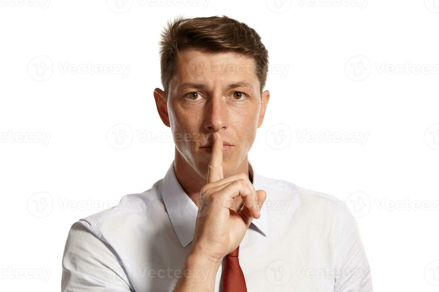 Portrait of a young brunet man posing in a studio isolated over a white background. photo