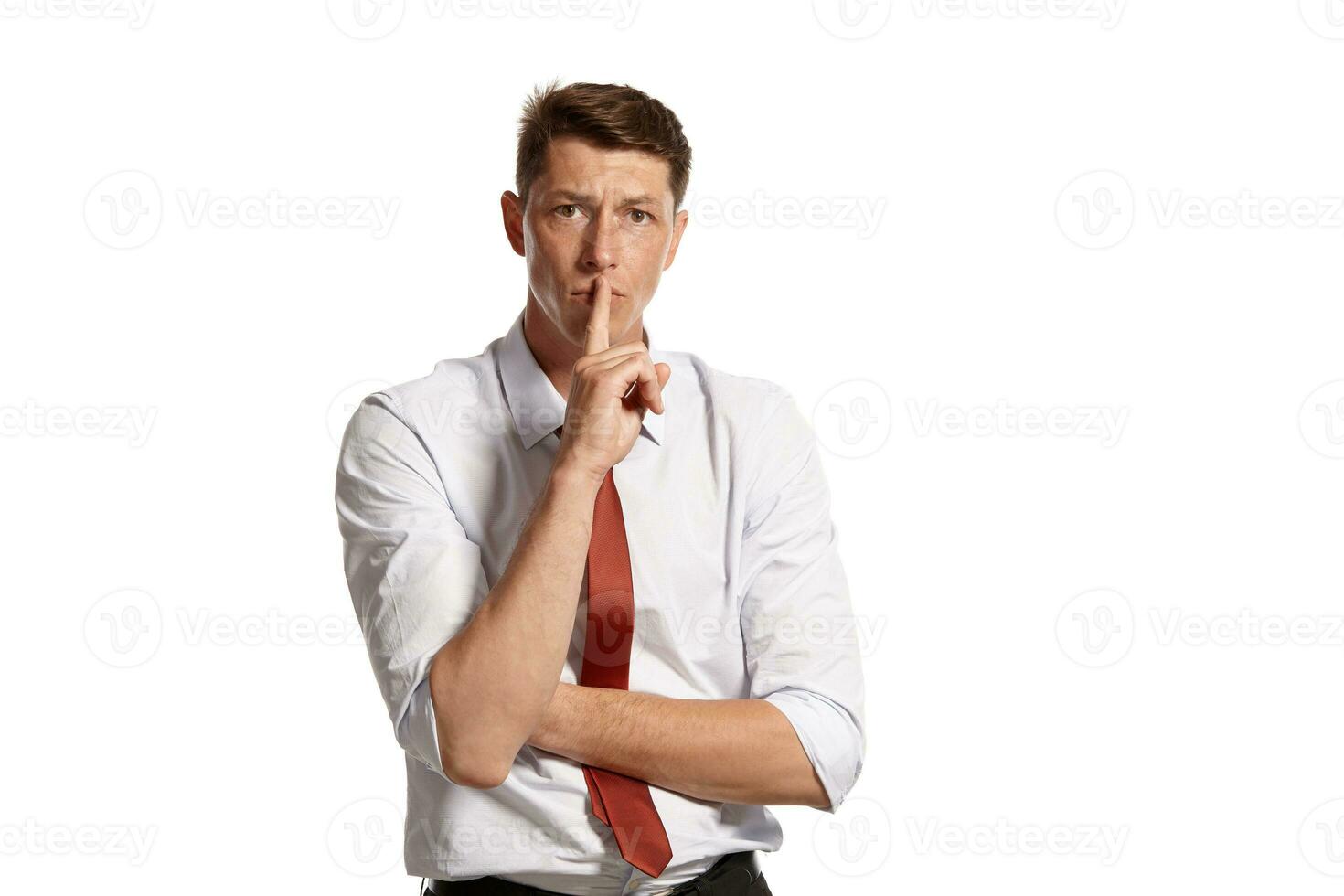 Portrait of a young brunet man posing in a studio isolated over a white background. photo