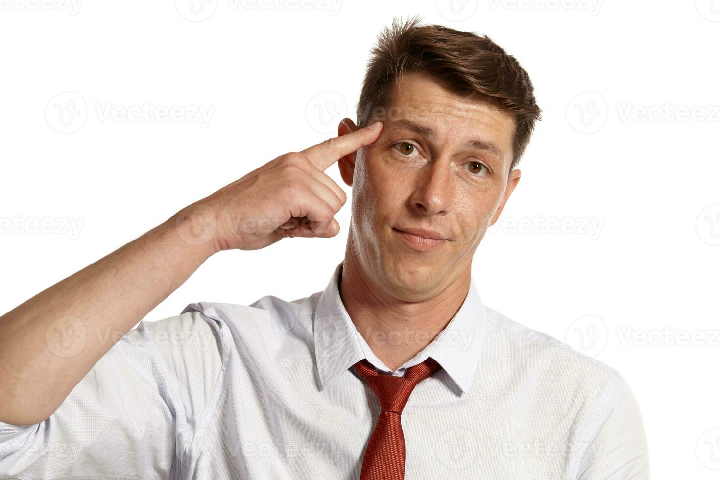 Young man in a classic white shirt and red tie posing isolated on white background. photo