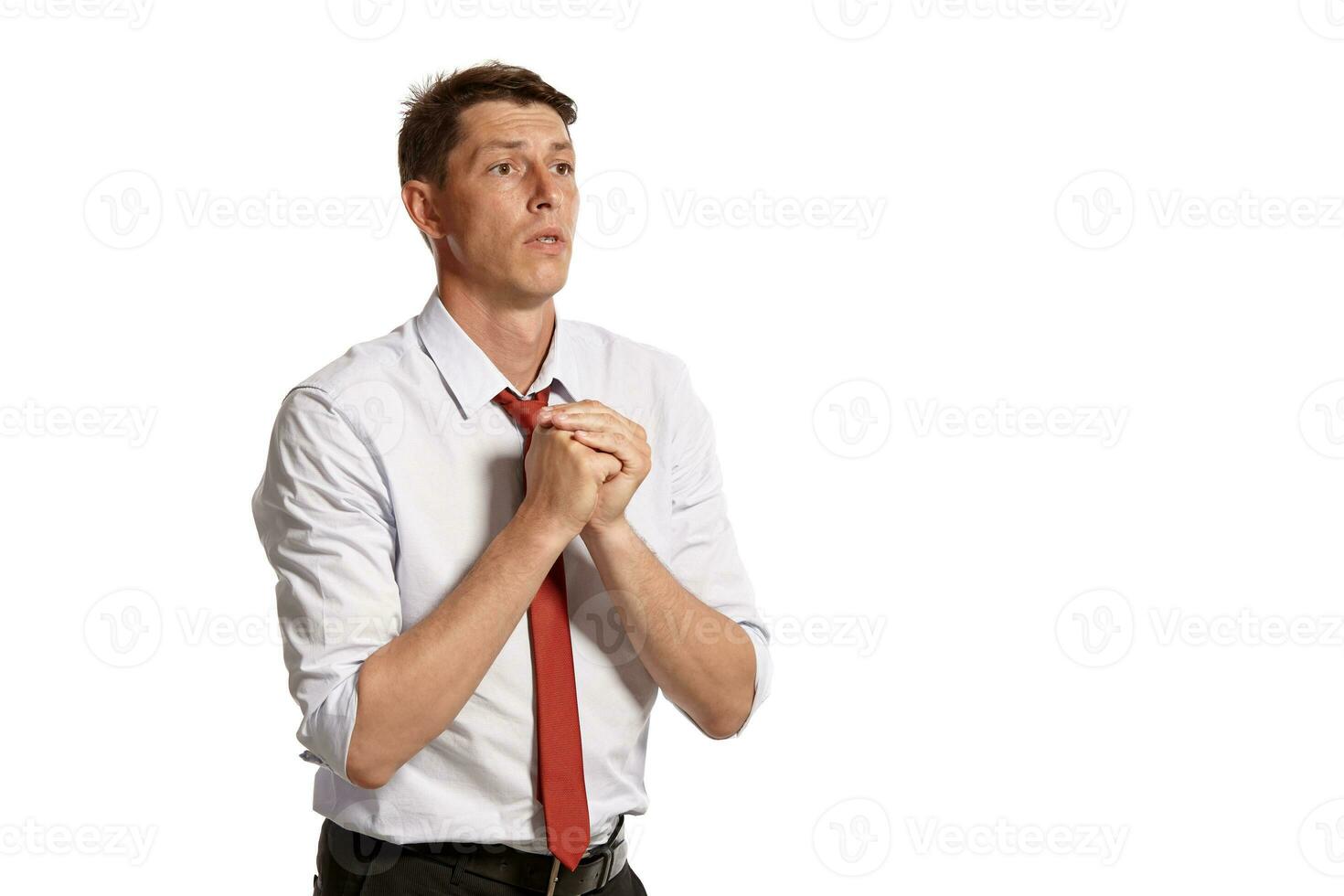 Portrait of a young brunet man posing in a studio isolated over a white background. photo