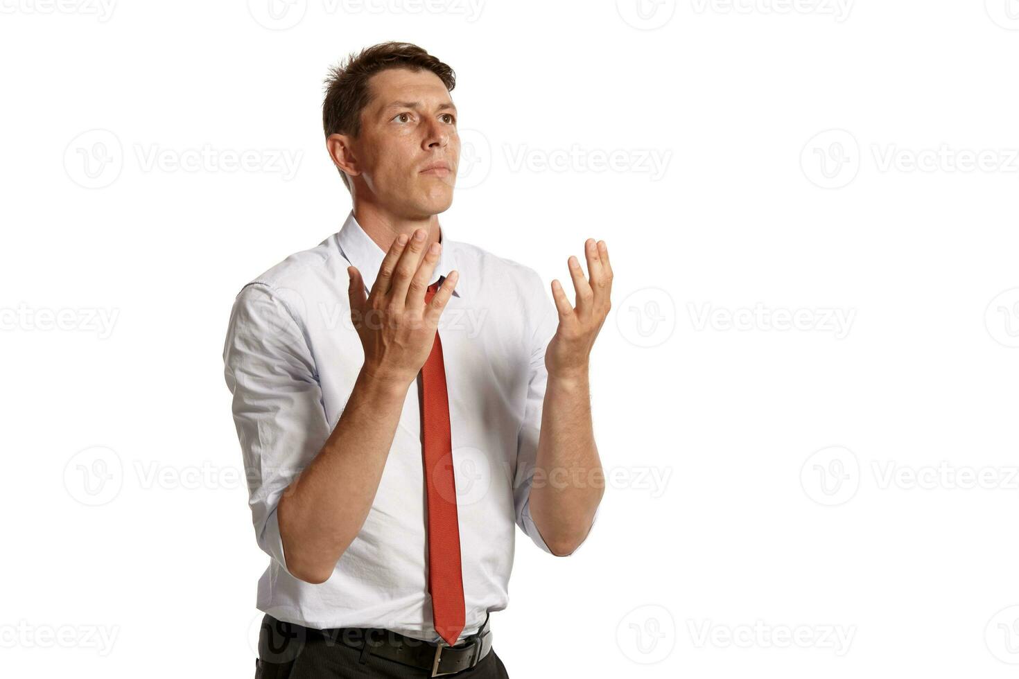 Portrait of a young brunet man posing in a studio isolated over a white background. photo