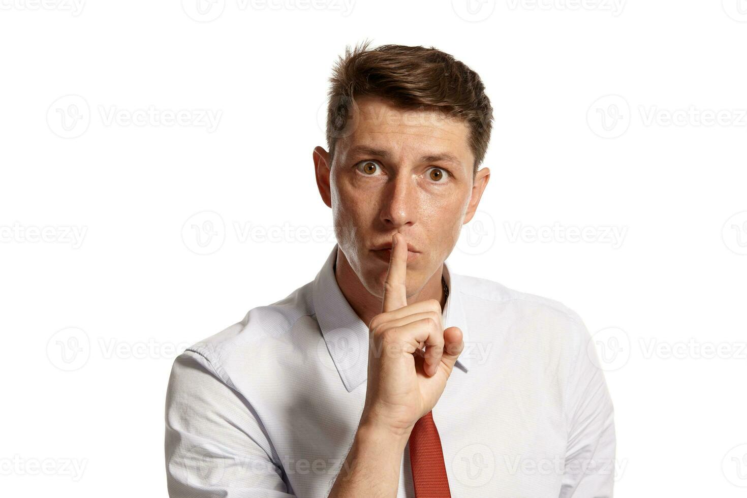 Portrait of a young brunet man posing in a studio isolated over a white background. photo