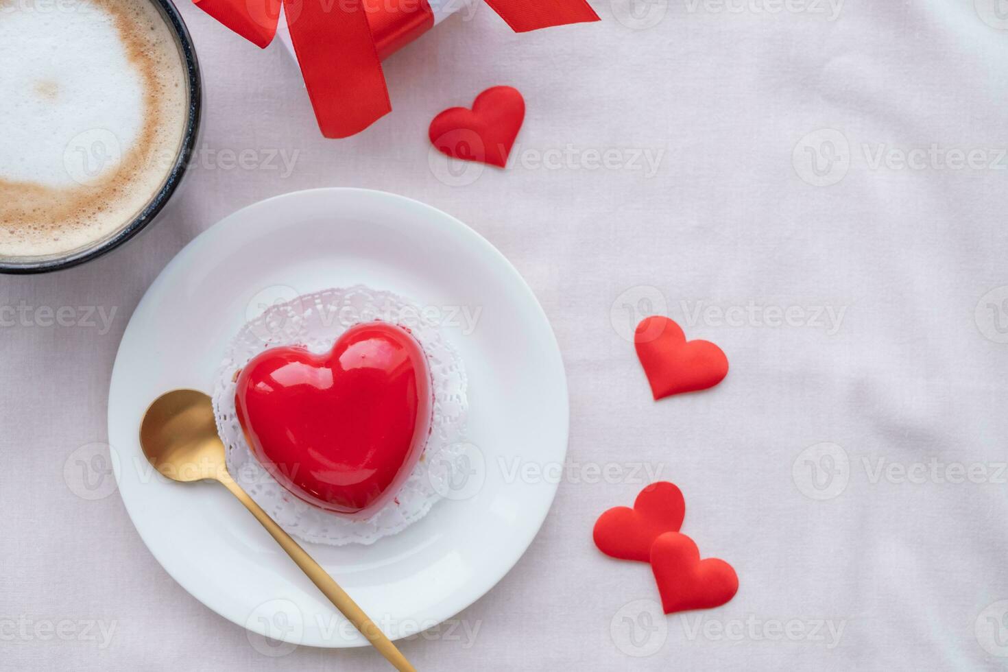 heart shaped glazed valentine cake in bed photo