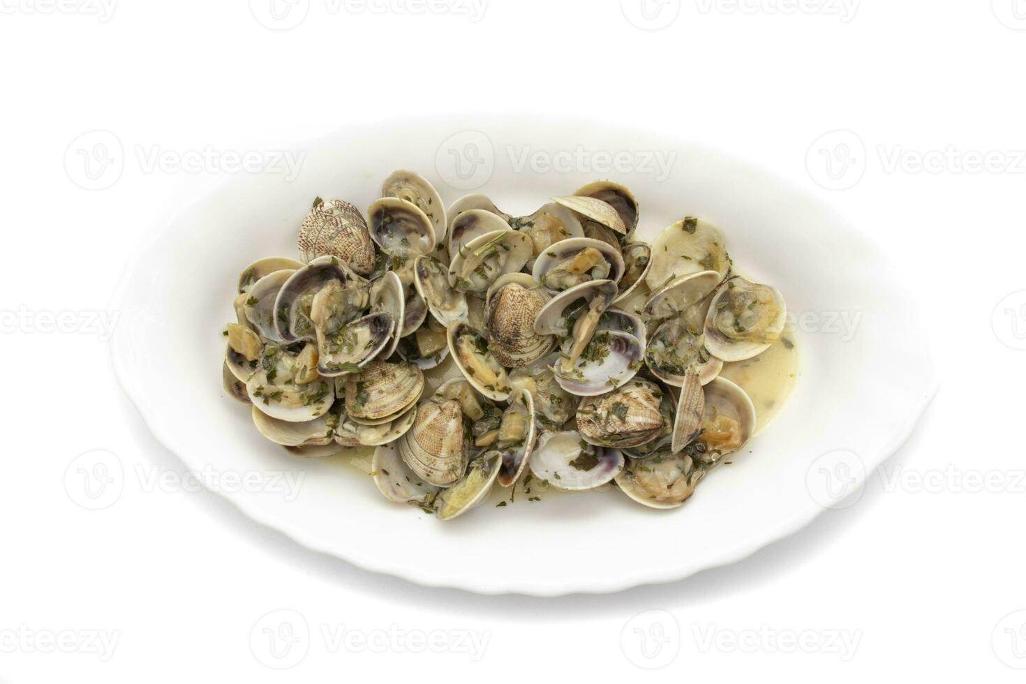 Clams dish with garlic, parsley, olive oil. Served hot. Isolated on white background. Spanish food photo