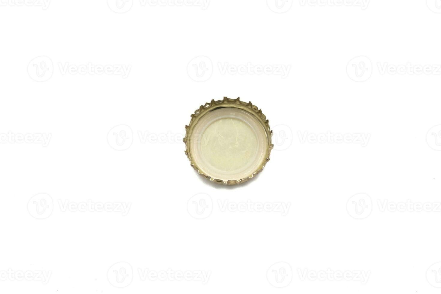 Gold colored beer bottle cap, to open and close. Isolated on white background. photo